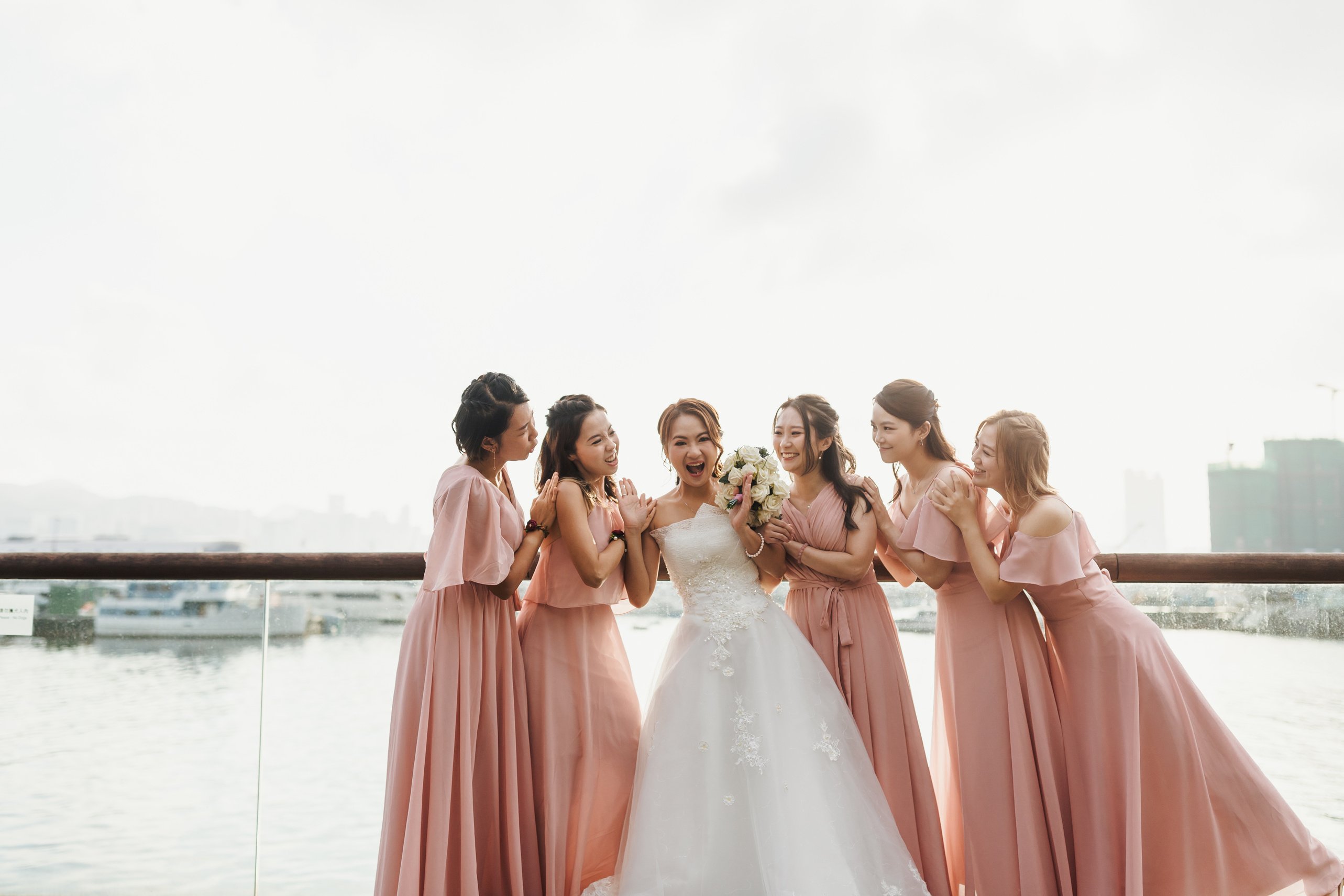 Bride and Her Bridemaids Standing on Pier 